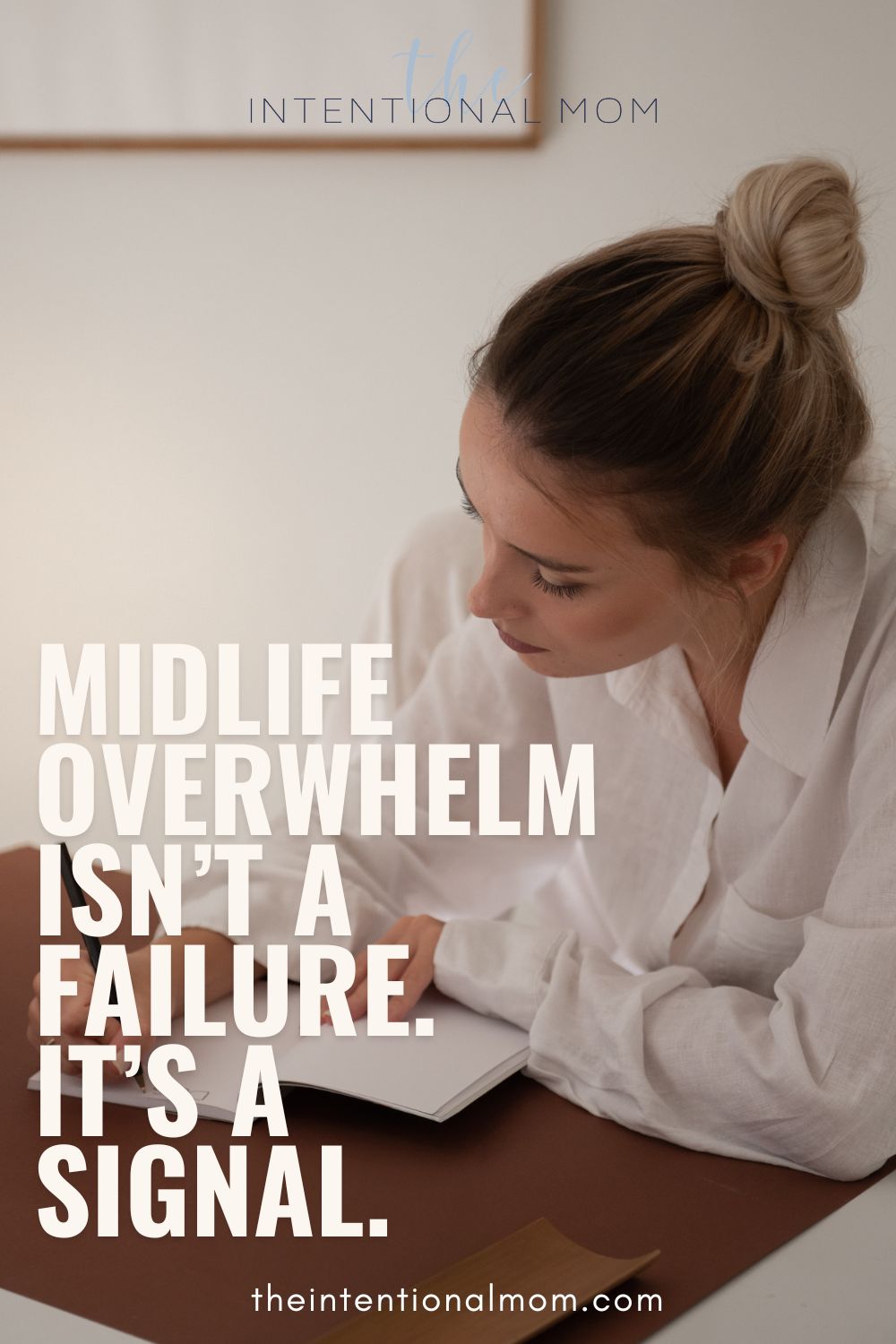 Woman writing in a journal as she pauses to regain clarity while feeling overwhelmed.